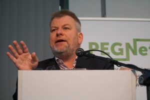 Markus Loewe speaking at the conference