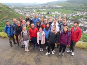 group photo outside in the mountains at Ahrtal, in the back the village
