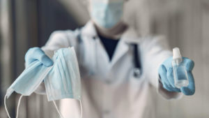 Image: Doctor with antiseptic. Coronavirus theme.