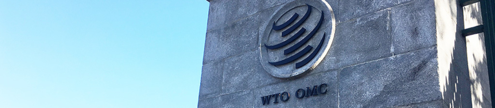 Image: Logo of the World Trade Organization on a column