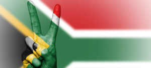 Image: Flag of South Africa, a hand in the same colors form the "V"-Victory-Sign