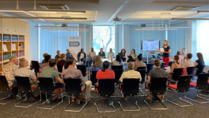 Photo: Roundtable Discussion on a podium inside IDOS in front of an educated audience.