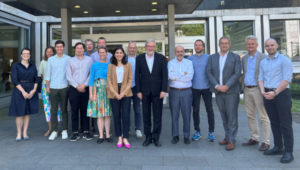 Photo: The chair of the OECD/DAC (Development Assistance Committee), Ambassador Carsten Staur in front of the IDOS Buidling with a group of IDOS experts