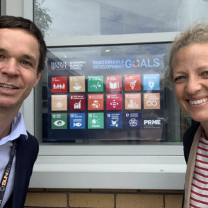 Photo: Wulf Reiners and Johanna Vogel in front of a Board with the Sustainable Development Goals (SDGs)