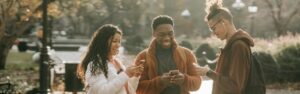 Photo: A group of young diverse people are busy with their smartphones