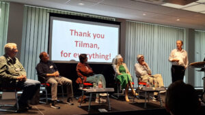 Panel of the Workshop, on the screen is written "Thank you Tilman for everything"
