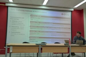 Photo of a presentation with PowerPoint slide