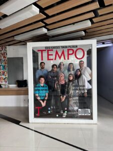 Group photo: The Postgraduate Programme (PGP) research team Indonesia standing behind a magazine-style picture frame.